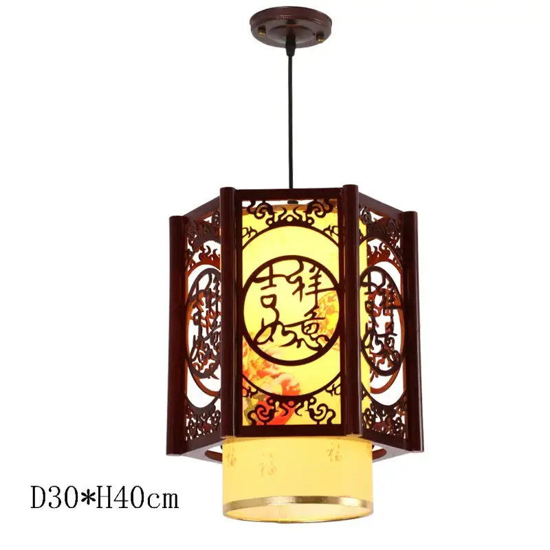 A warm-toned decorbites antique wood pendant light with dark wood frame and glowing yellow interior for dining room