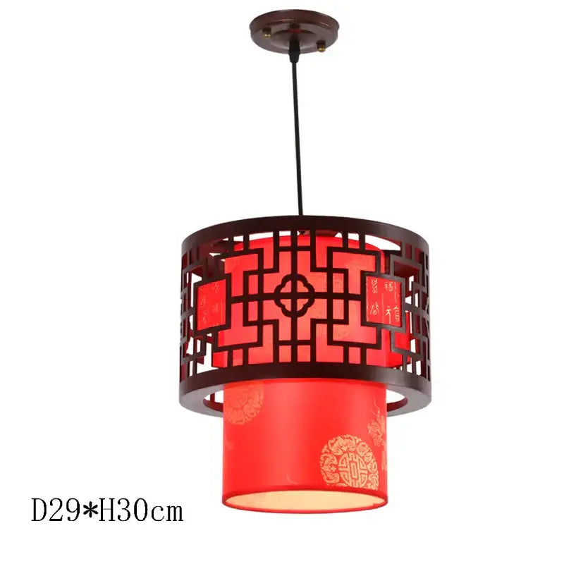 Red lantern-style pendant lights with dark wooden frame and intricate lattice design by decorbites antique wood pendant