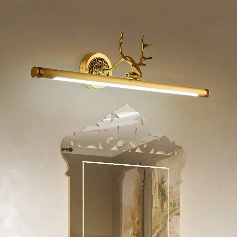 Gold-toned DecorBites antler 8W LED mirror light sconce with decorative deer head for bedroom and bathroom use
