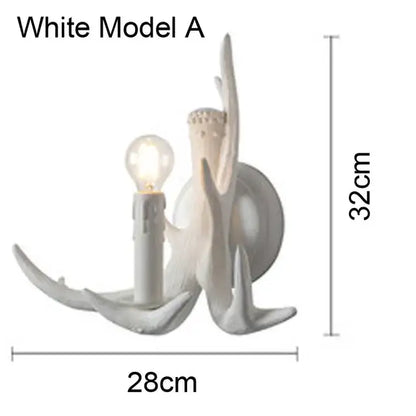 White ceramic wall sconce resembling a stylized candle with branching antler arms in decorbites antler chandelier design