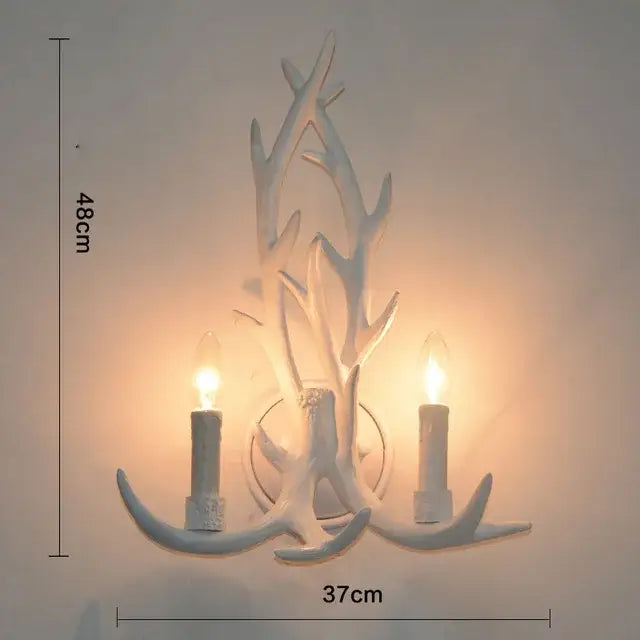 White antler-themed wall sconce with two candle-style lights from decorbites antler pendant chandelier collection