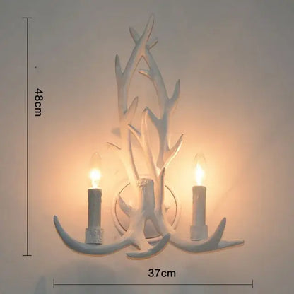 White antler-themed wall sconce with two candle-style lights from decorbites antler pendant chandelier collection