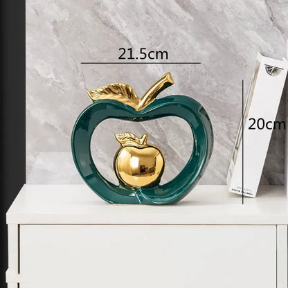 Glossy teal ceramic decorbites apple hollow candy jar featuring gold leaf stem and inner golden apple replica for home decor