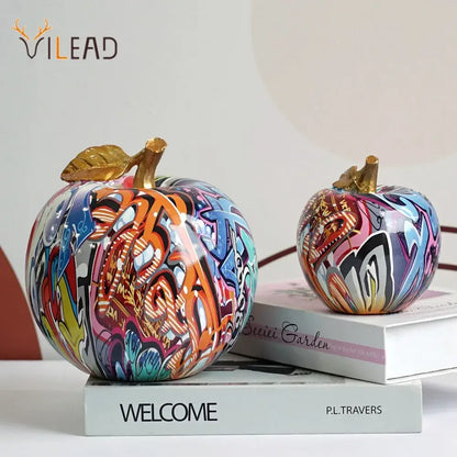 DecorBites apple sculpture resin ornament with vibrant graffiti paint and golden leaf stems for modern interior decor