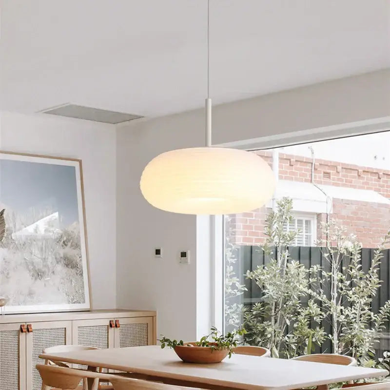 A decorbites apple shape ceiling chandelier featuring a modern off-white cloud-like shade suspended by a slender metallic rod