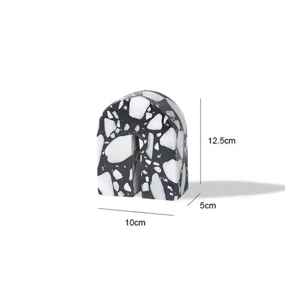 Black and white terrazzo sculpture in an arch shape with speckled stone texture decorbites archway terrazzo bookend