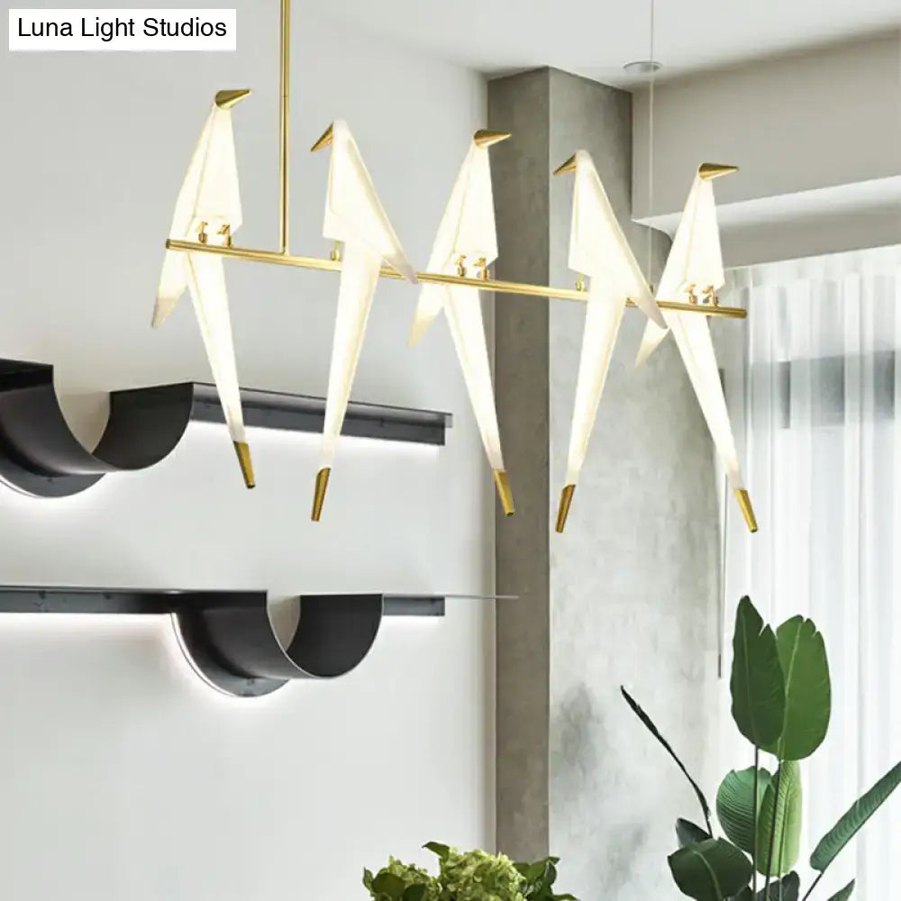 Modern art deco acrylic bird island pendant light with five white and gold origami-style LED birds