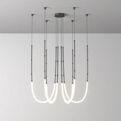 Modern minimalist DecorBites Art Deco pendant light with gold and black metallic rods and white curved LED tubes for dining room