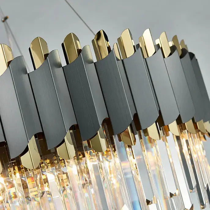 A modern pendant light with matte black and gold panels and hanging crystal prisms from decorbites art deco