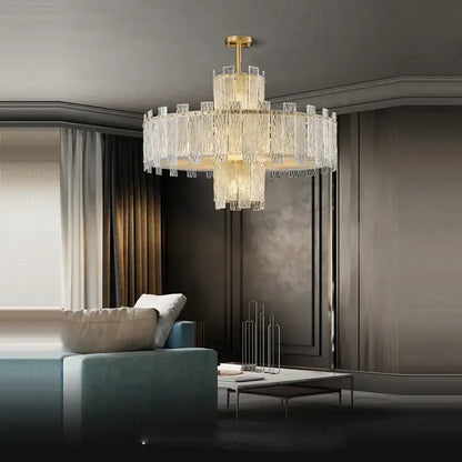 Decorbites art deco multi-tiered chandelier with cascading crystal prisms and polished deco golden copper finish