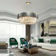 A decorbites art deco gray and gold crystal chandelier with circular metallic frame and cascading golden strands