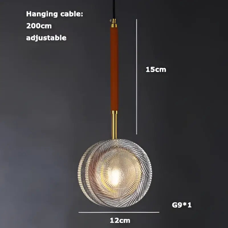 A modern glass pendant light by DecorBites Art Deco with circular textured design and warm golden glow, art deco LED style