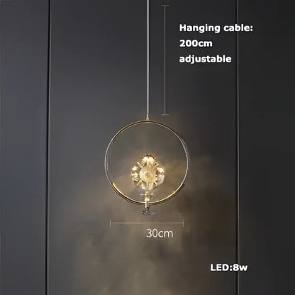 A modern circular gold-toned decorbites art deco pendant light with eight led bulbs and intricate vintage design