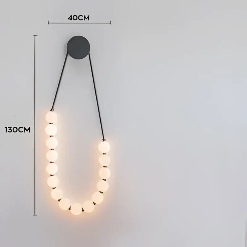 Modern black DecorBites Art Deco pendant light with warm glowing spherical bulbs in an elegant U-shape design