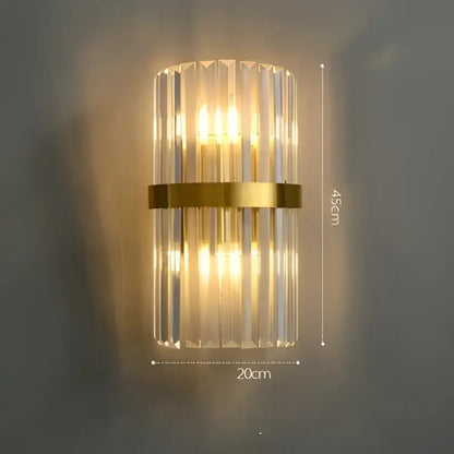 Modern wall sconce with vertical crystal rods and gold-toned metal band from DecorBites Art Deco LED collection