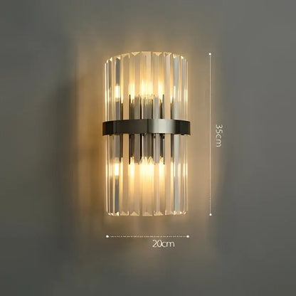Decorbites art deco wall sconce with vertical crystal rods and black metal band emitting warm light for bedroom and corridor
