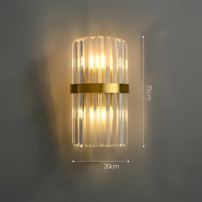 Decorbites art deco led wall sconce with vertical crystal prisms and gold-toned stainless steel band for bedroom lighting