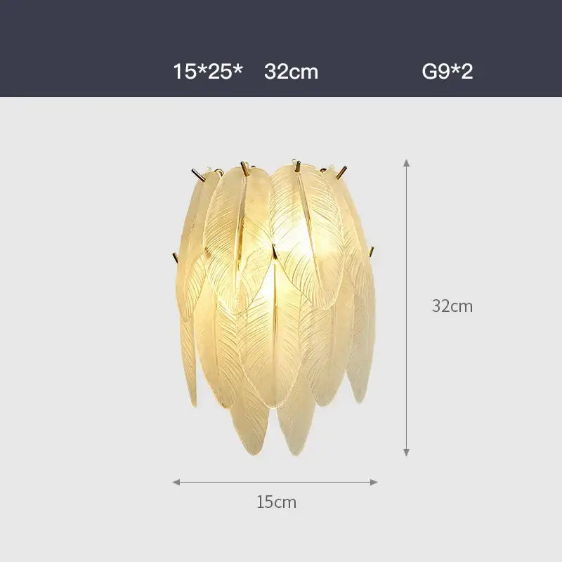 Golden feather-shaped pendant light with intricate leaf detailing in decorbites art deco white glass chandelier style