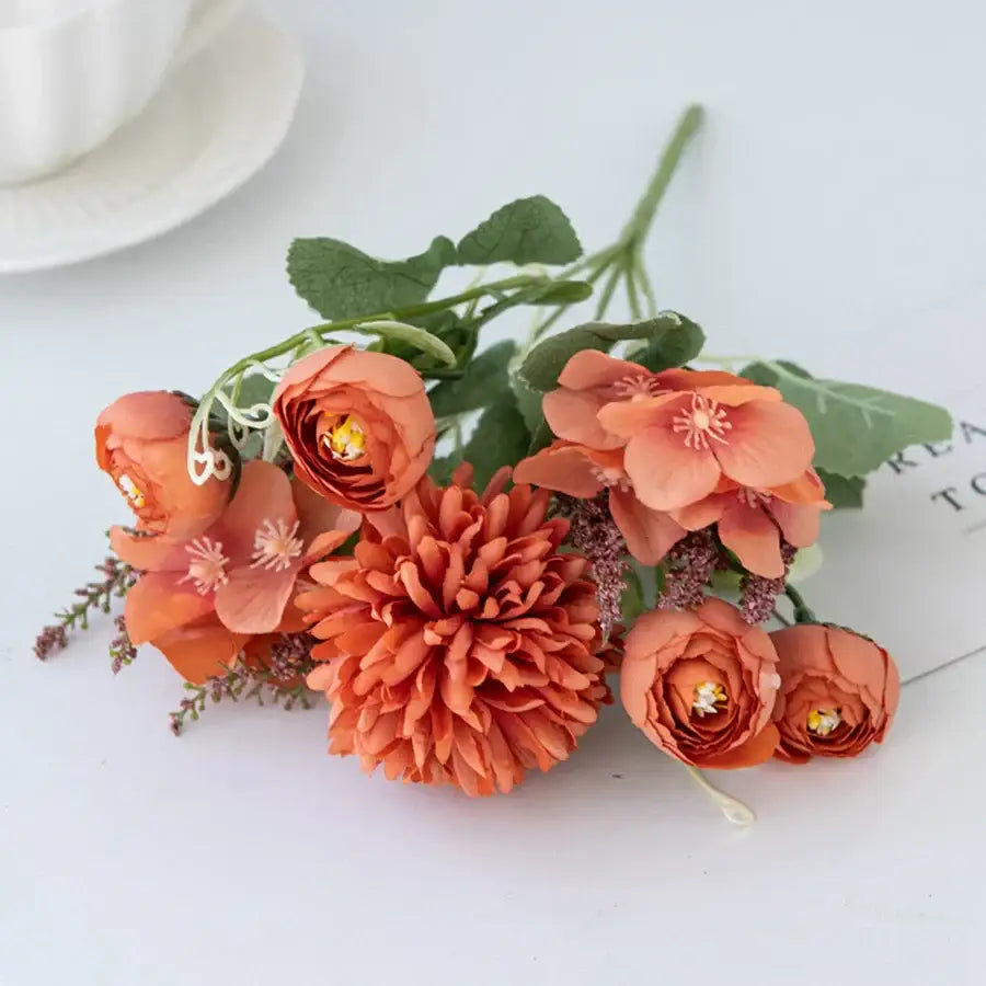 A cluster of decorbites artificial hydrangea tea orange flowers with green stems featuring ruffled petals and delicate centers