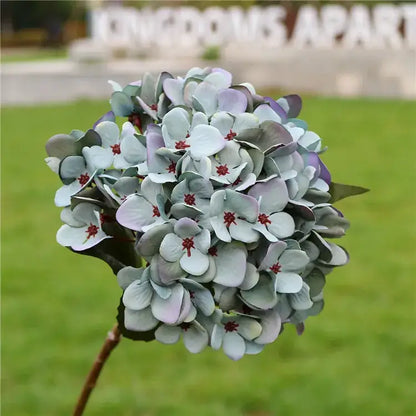 Decorbites artificial hydrangea wedding flowers with lavender and pale blue petals accented by deep red centers for indoor decor