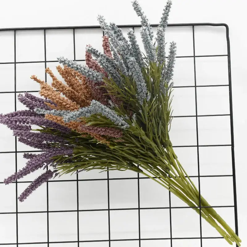 A bouquet of DecorBites™ artificial lavender plants in purple gray and brown with green foliage for home decor and wedding diy