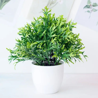 A decorbites artificial mini green plant bonsai with serrated leaves in a white ceramic pot for desktop decor