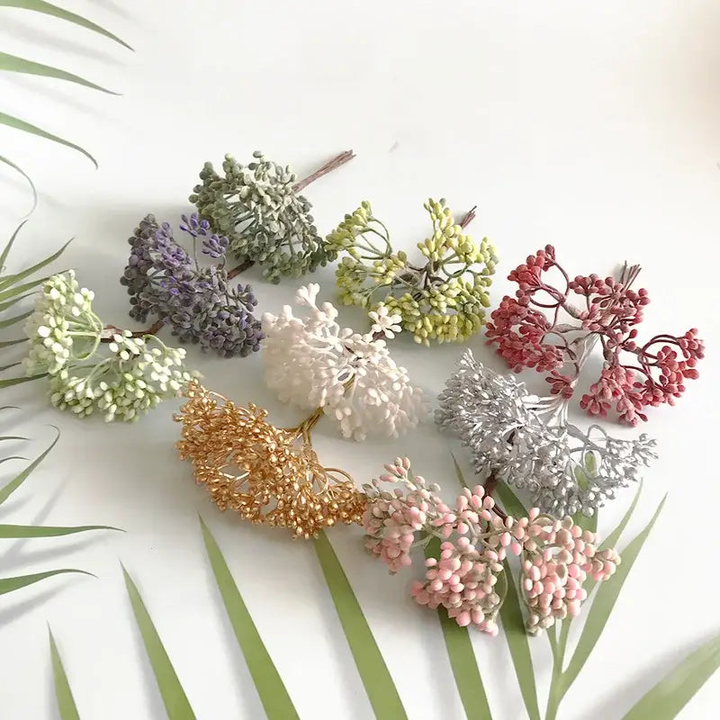 A collection of decorbites artificial plants diy garland clusters in pastel and metallic hues mimicking dried plants textures