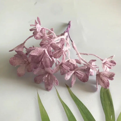A delicate cluster of lavender artificial plants with glittery hydrangea blossoms from decorbites artificial plants collection