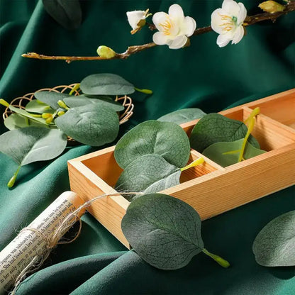 Light brown wooden tray with three compartments holding artificial eucalyptus leaves from decorbites artificial roses collection for home wedding christmas decor