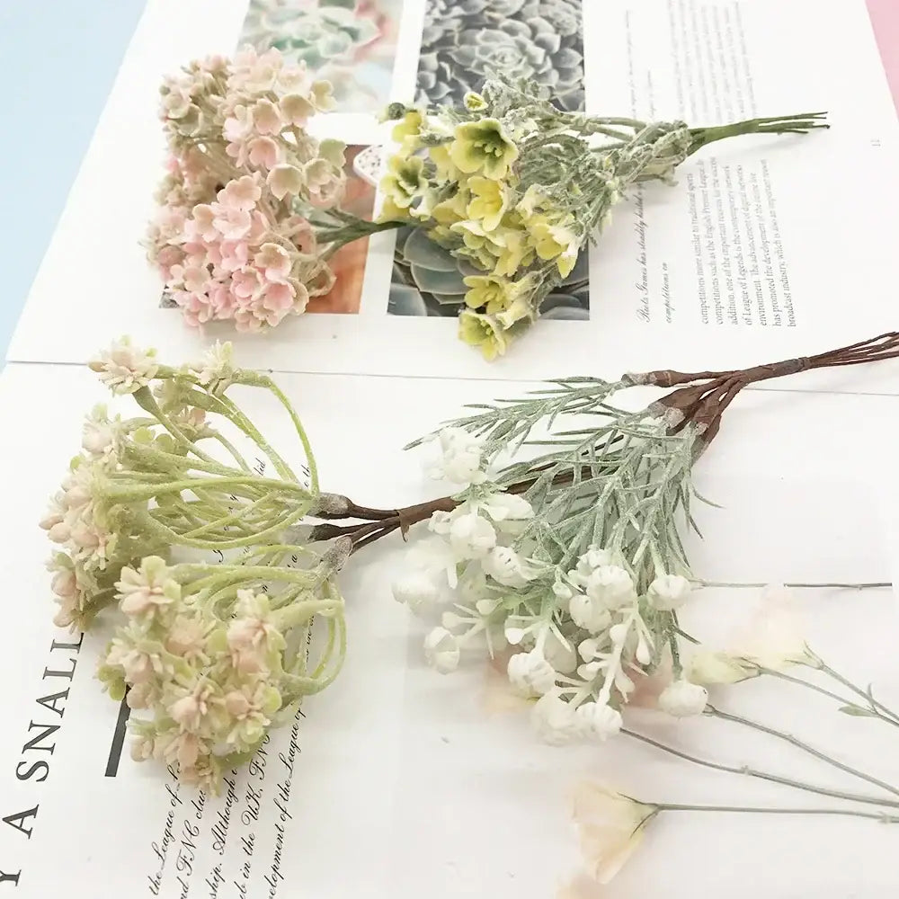 Delicate artificial succulent tree sprigs in pastel pink, pale green, and white with textured stems for home decor