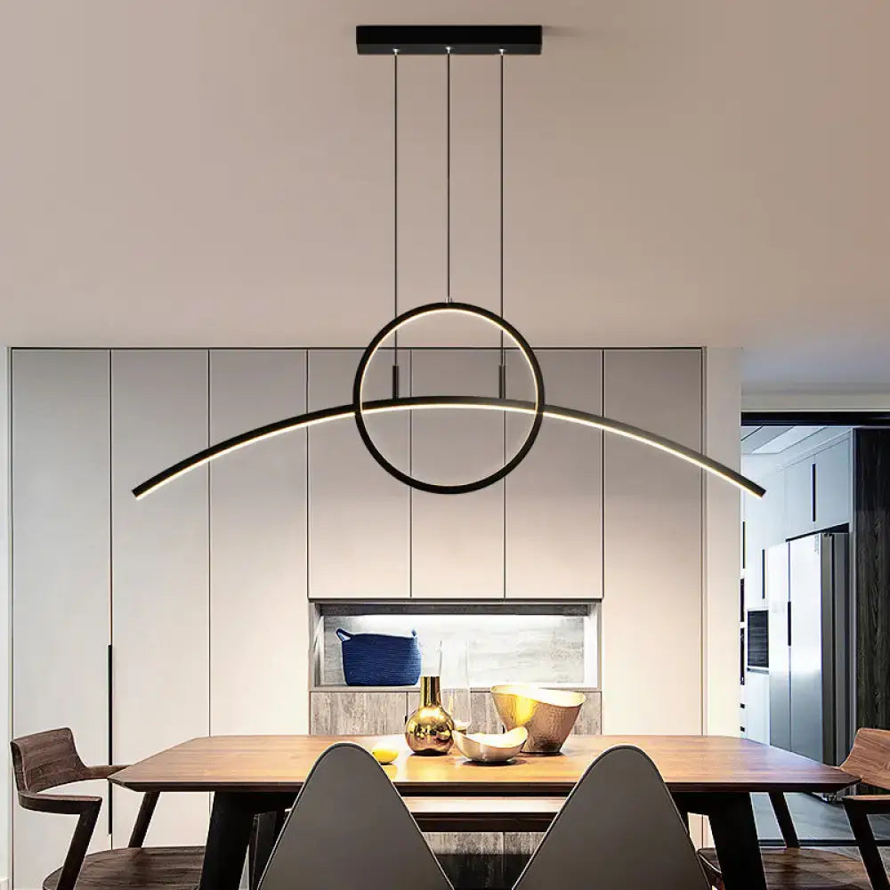 Modern black circular metal ceiling light fixture with sleek curved LED arc design for dining room by DecorBites