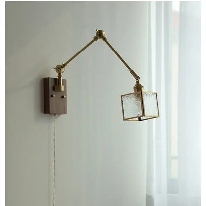 Brass-finished decorbites ash wood led wall lamp with adjustable arm and textured glass cube shade on wooden base