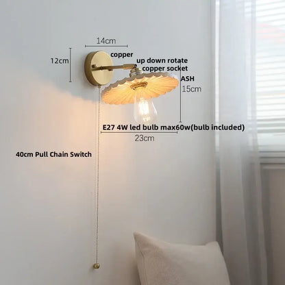 Copper wall lights with scalloped amber glass shade and exposed bulb in decorbites ash wood up down design
