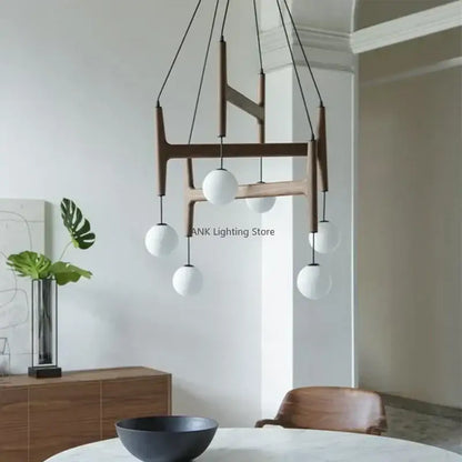 Modern wooden chandelier featuring five white spherical glass globes by DecorBites ASTRA wood pendant light
