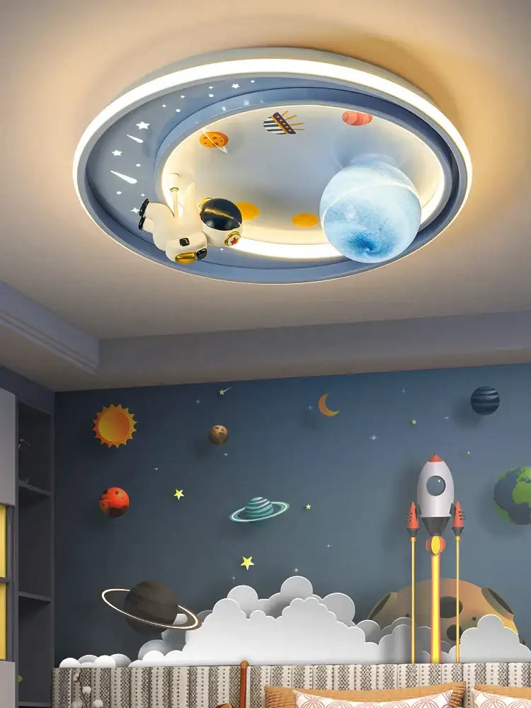 A circular ceiling light decorbites astronaut astros featuring a white astronaut figurine and illuminated blue orange yellow planets