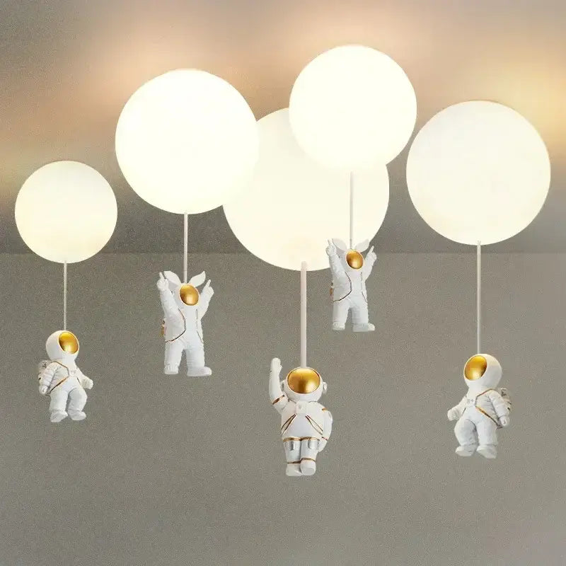 Decorbites astronaut balloon ceiling lamp featuring white astronaut figurines with gold helmets holding spherical lights