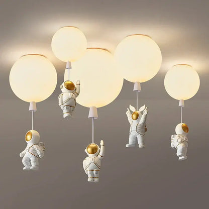 Decorbites astronaut balloon led pendant light featuring white astronaut design with gold accents and spherical globe shades for nursery room
