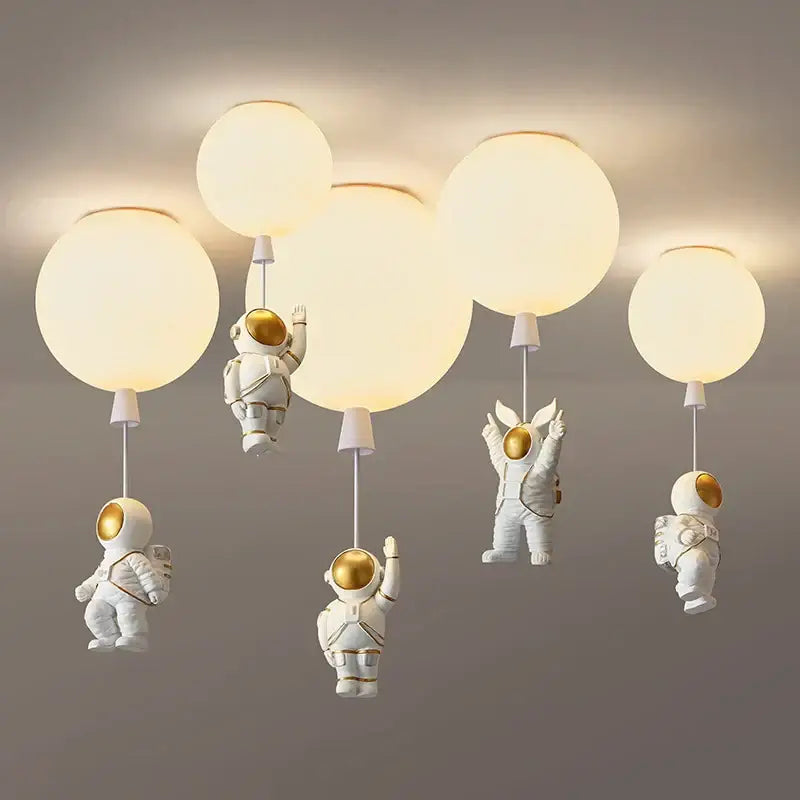Decorbites astronaut balloon led pendant light featuring white astronaut design with gold accents and spherical globe shades for nursery room