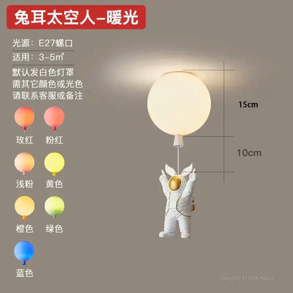 White astronaut figurine with gold accents holding a warm light spherical pendant light decorbites astronaut balloon led