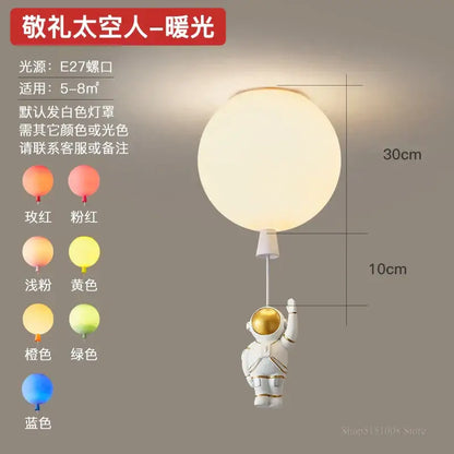 White astronaut figurine with gold accents holding a softly glowing spherical pendant light decorbites astronaut balloon