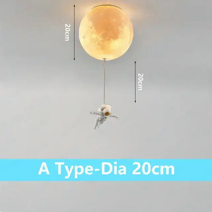 A glowing 20cm moon-shaped ceiling light with a dangling astronaut figure in the DecorBites astronaut bubble chandelier