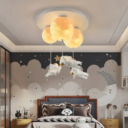 Whimsical decorbites astronaut bubble chandelier light with three glowing yellow moons above white astronaut figurines
