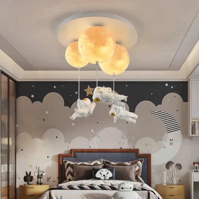 Whimsical decorbites astronaut bubble chandelier light with three glowing yellow moons above white astronaut figurines