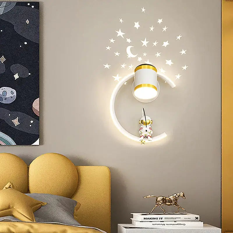 Decorbites astronaut cartoon wall lamp featuring a white and gold crescent moon with a glowing astronaut figure