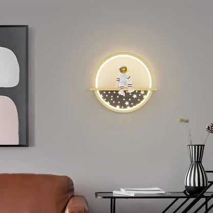 Decorbites astronaut cartoon led wall lamp with glowing circular light and white astronaut figurine on golden ledge