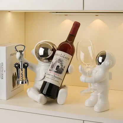 Decorbites astronaut ceramic white figurines with silver helmets function as an astronaut ceramic wine rack and bar accessory