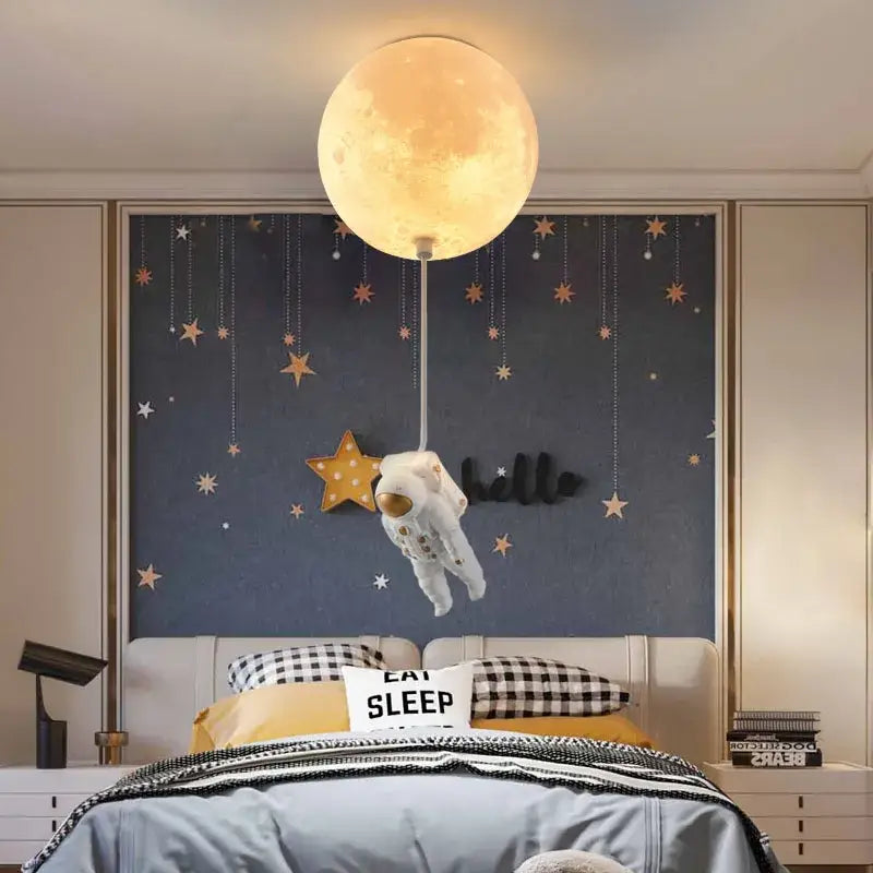 Glowing textured moon-shaped ceiling light with white astronaut figure hanging below decorbites astronaut globe