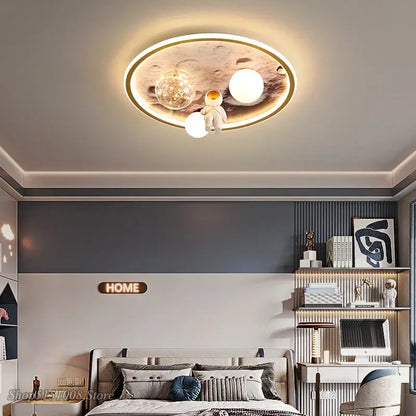Circular decorbites astronaut led ceiling light with gold frame, astronaut figurine, and three white and clear bulbs for kids room