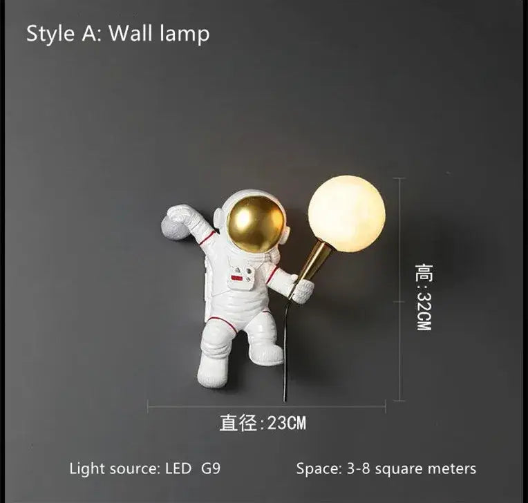 White resin decorbites astronaut led desk lamp with gold helmet holding a glowing spherical light fixture