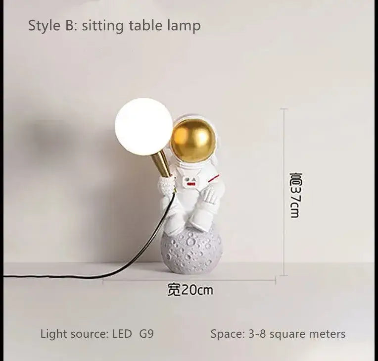 Decorbites astronaut led desk lamp featuring white resin astronaut with gold helmet and spherical led on gray moon base